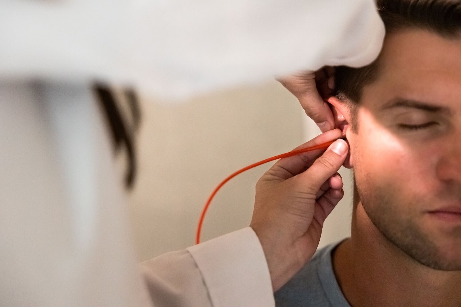 An audiologist performing a hearing test